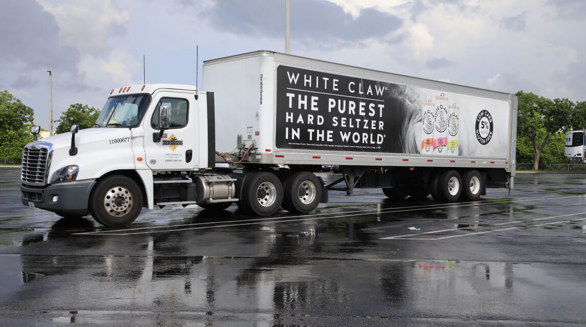 Large truck with "white claw" banner on it